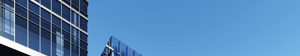 Modern financial services office buildings against clear blue sky