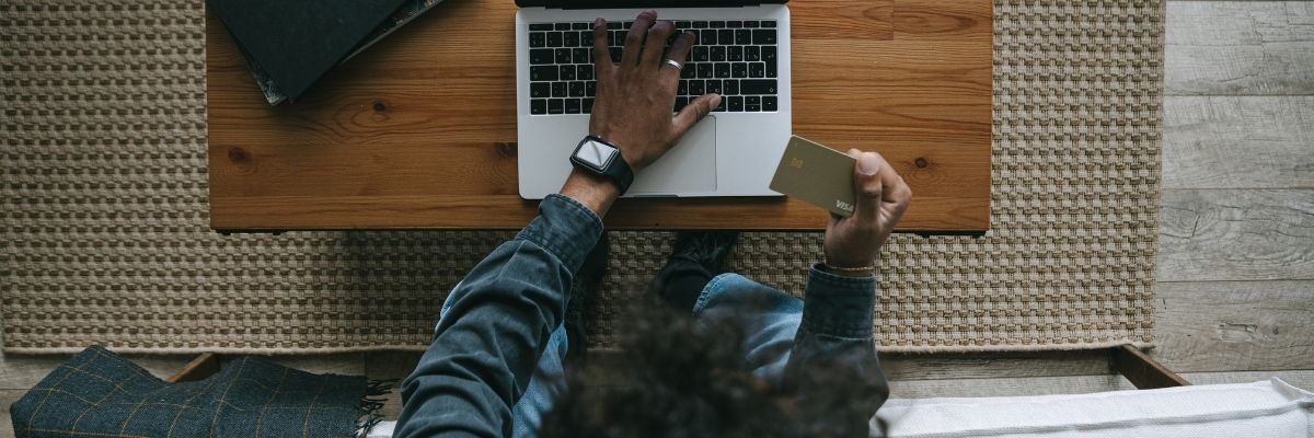 Contractor applying for a surety bond online with a laptop and payment card