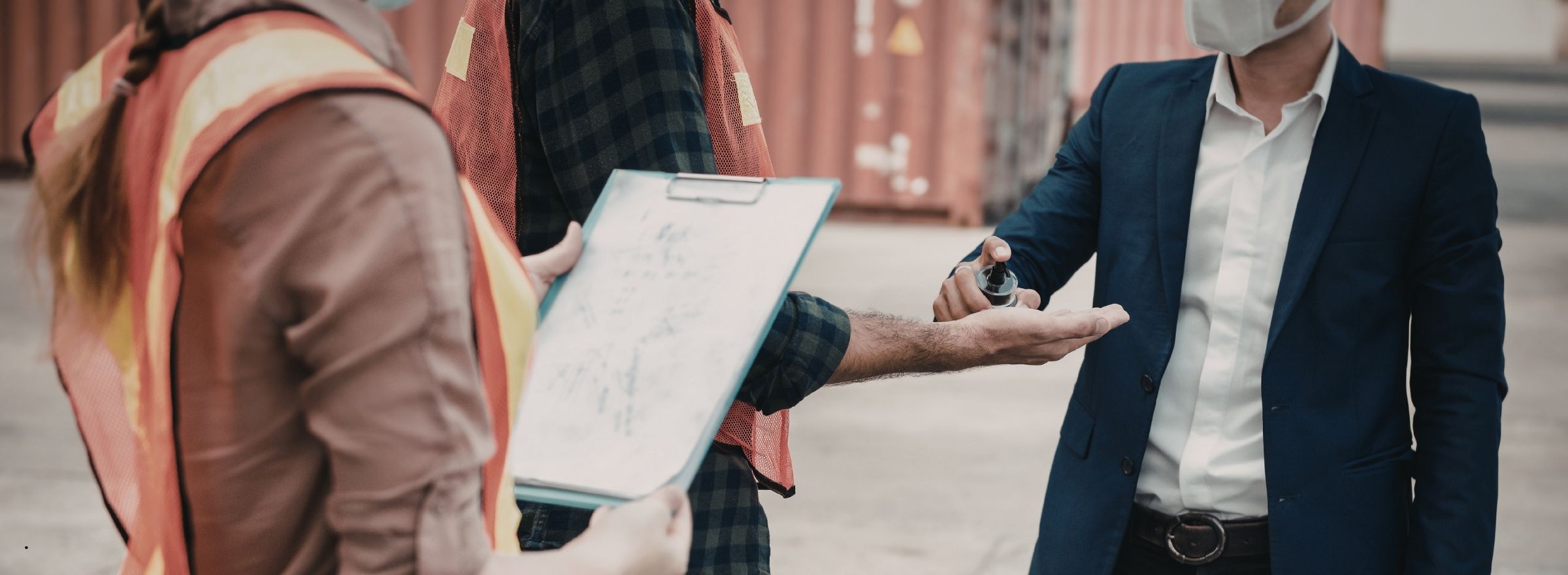 Contractors reviewing bond documents at job site with surety agent